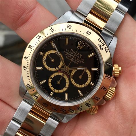 rolex daytona two tone gold dial black ring|Rolex daytona gold black face.